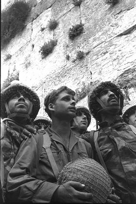 Israeli paratroopers stand in front of the Western Wall in Jerusalem.